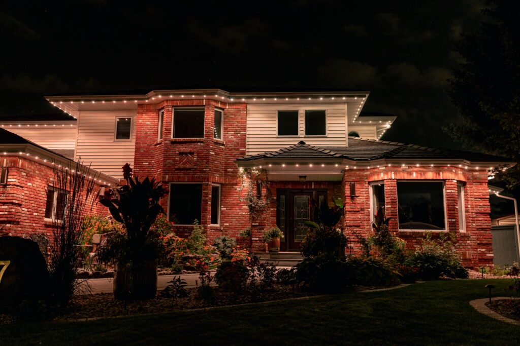 Permanent Christmas lights illuminating a house exterior
